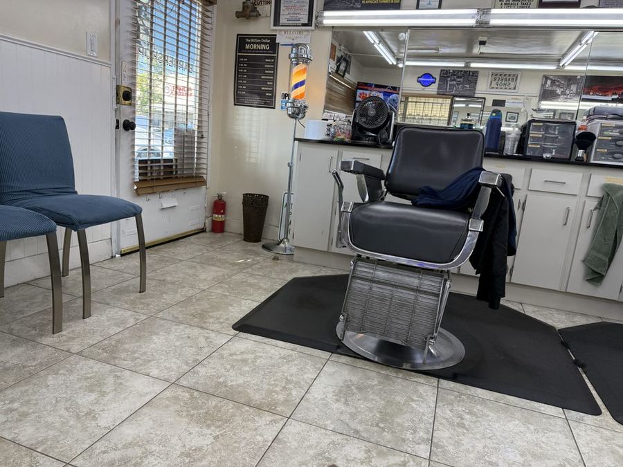 Inside our shop: a vintage chrome barber chair on a clean tile floor